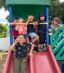 Children playing together on the playground slide