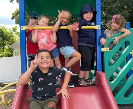 Children playing together on the playground slide